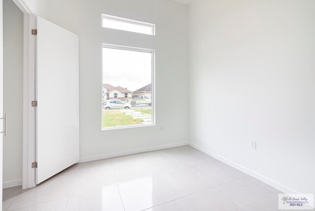 spare room with light tile patterned floors