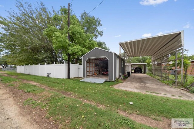 view of yard featuring an outdoor structure and a carport