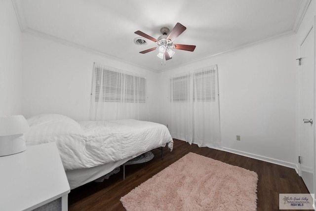 bedroom featuring ceiling fan, dark hardwood / wood-style floors, and ornamental molding