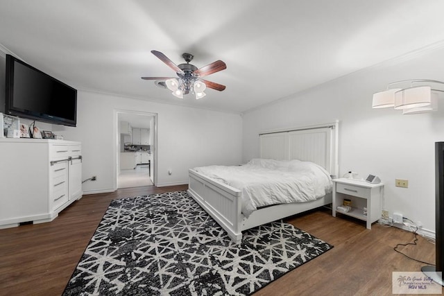 bedroom featuring dark hardwood / wood-style flooring, a closet, ceiling fan, and crown molding