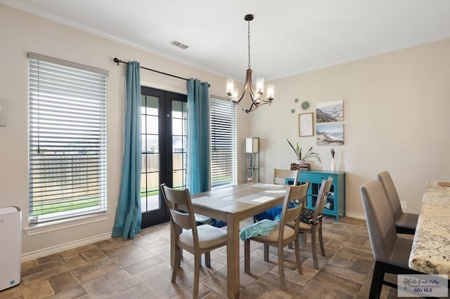 dining area with a chandelier and ornamental molding