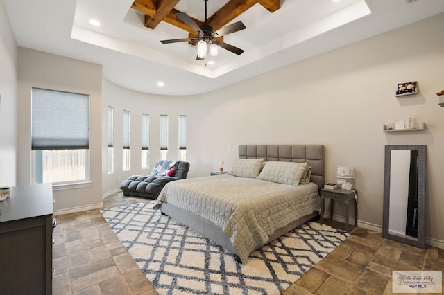 bedroom featuring a tray ceiling, ceiling fan, and coffered ceiling