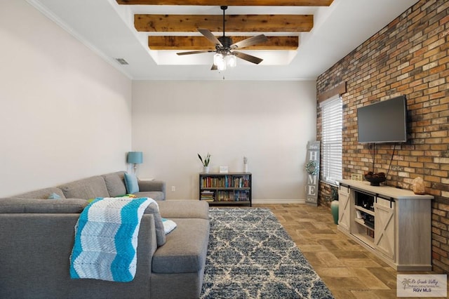 living room featuring beamed ceiling, ceiling fan, and brick wall