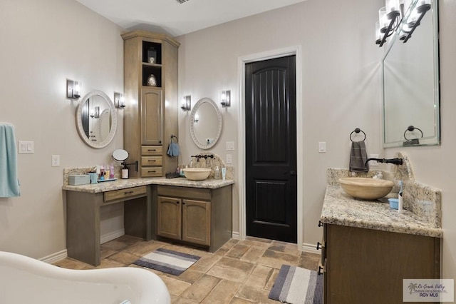 bathroom featuring vanity and a tub to relax in