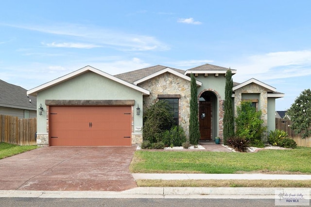 view of front of home featuring a front lawn and a garage