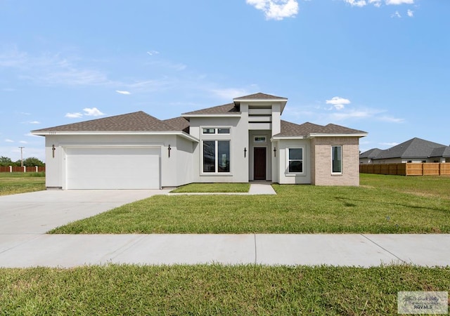 prairie-style home with a garage and a front yard