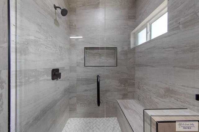 bathroom with tiled shower