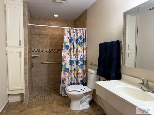 bathroom featuring vanity, toilet, and walk in shower