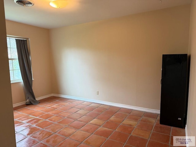 spare room with tile patterned floors