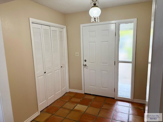 entryway with a textured ceiling