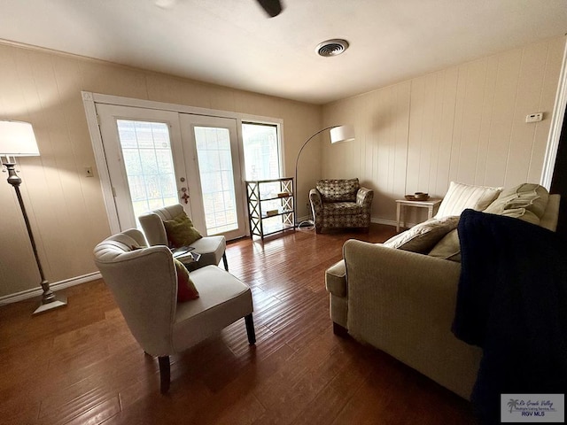 sitting room featuring dark wood-type flooring and french doors