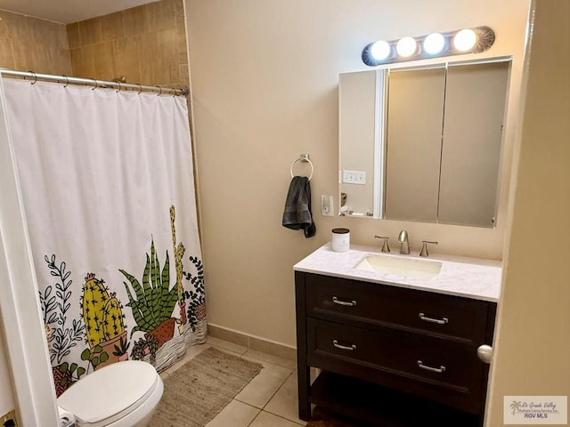 bathroom with vanity, walk in shower, tile patterned floors, and toilet