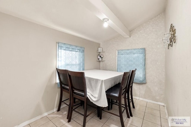 tiled dining area featuring lofted ceiling with beams