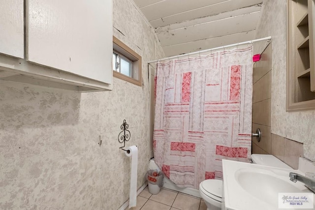 full bathroom featuring tile patterned flooring, vanity, toilet, and shower / bathtub combination with curtain