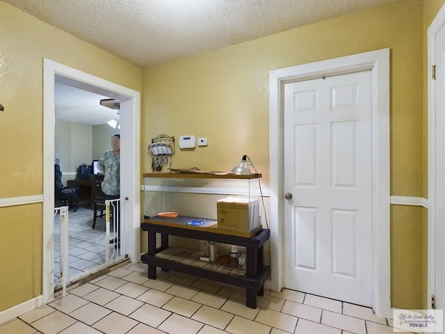 hall with a textured ceiling