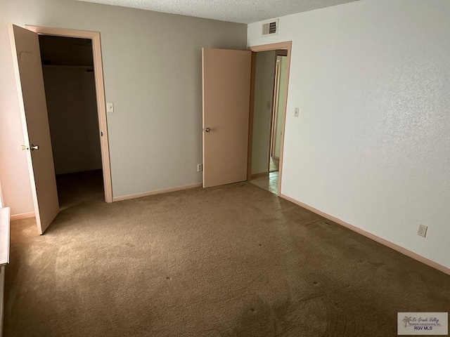 2901 Central Blvd, Brownsville, TX 78520 - unfurnished bedroom with carpet, a textured ceiling, and baseboards