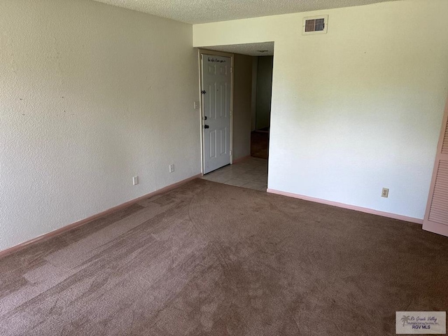 2901 Central Blvd, Brownsville, TX 78520 - empty room with light colored carpet, baseboards, and a textured ceiling