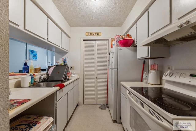 2901 Central Blvd, Brownsville, TX 78520 - kitchen featuring white electric stove, light flooring, under cabinet range hood, a textured ceiling, and white cabinets