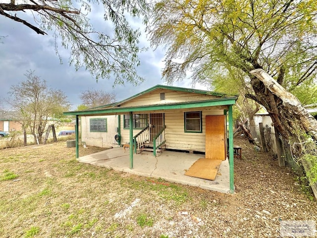 exterior space with entry steps, a patio, a front lawn, and fence