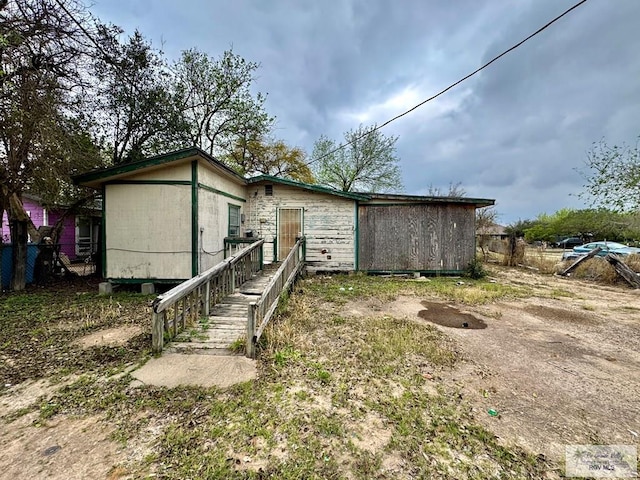 rear view of house featuring fence