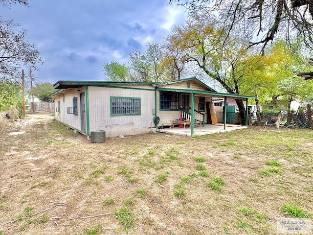 rear view of property with fence