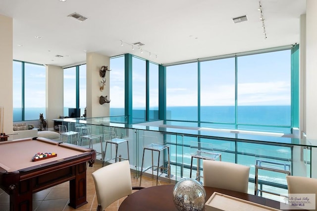 game room with floor to ceiling windows, light tile patterned flooring, track lighting, a water view, and pool table