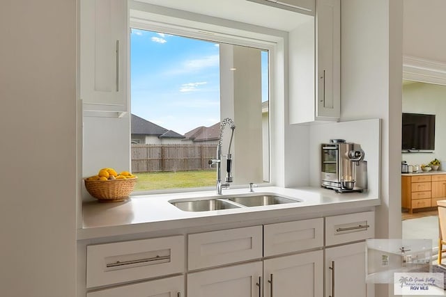 kitchen with white cabinetry and sink