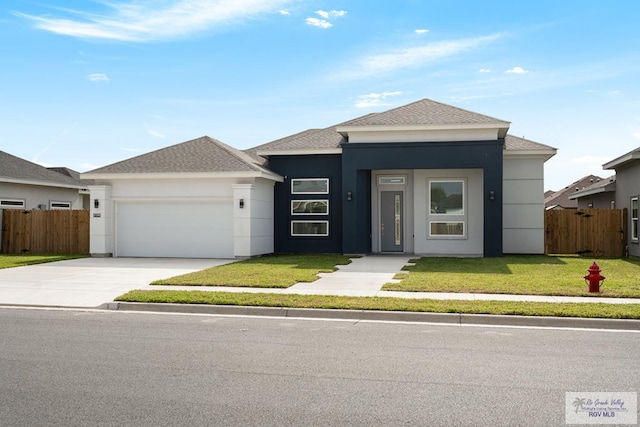 view of front of property featuring a garage and a front lawn