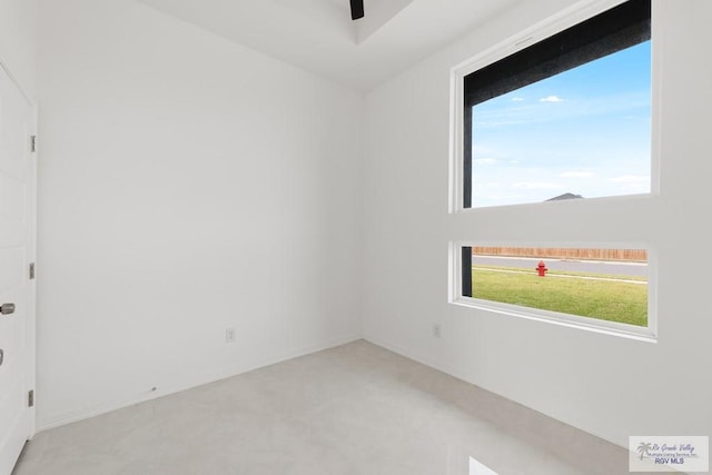 unfurnished room featuring light colored carpet and ceiling fan