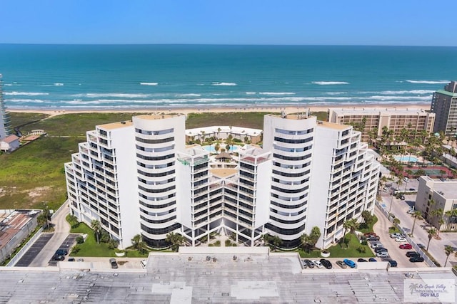 bird's eye view with a water view and a beach view