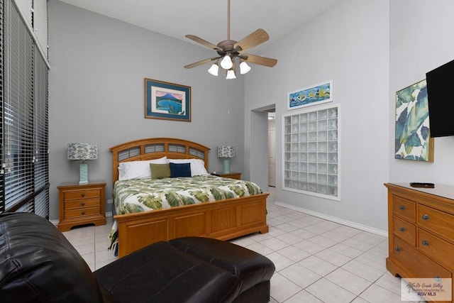 bedroom with ceiling fan, a closet, high vaulted ceiling, and light tile patterned floors