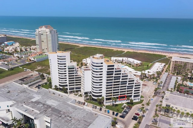 birds eye view of property featuring a beach view and a water view