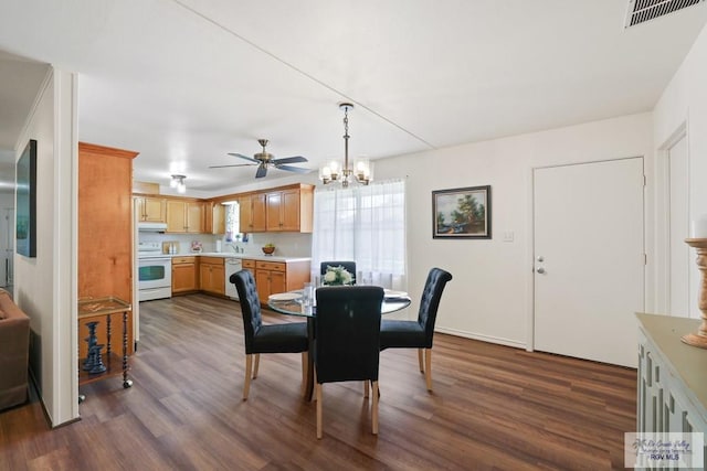 dining area with dark wood-style floors, visible vents, and ceiling fan with notable chandelier