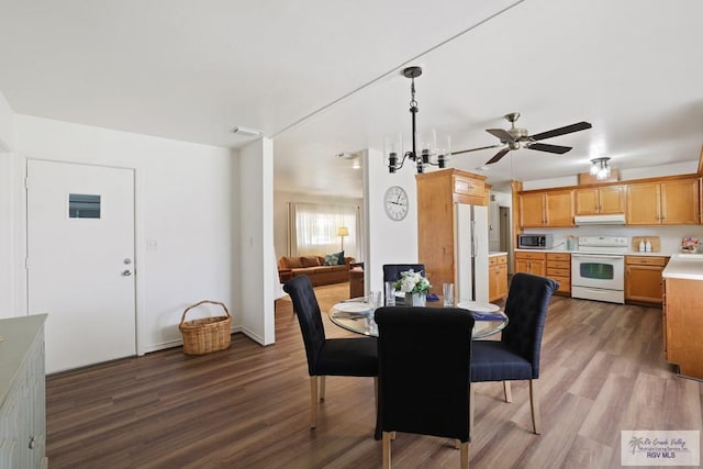 dining room featuring a ceiling fan, visible vents, and wood finished floors