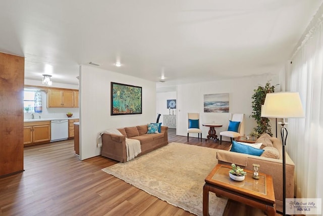living area featuring visible vents and light wood finished floors