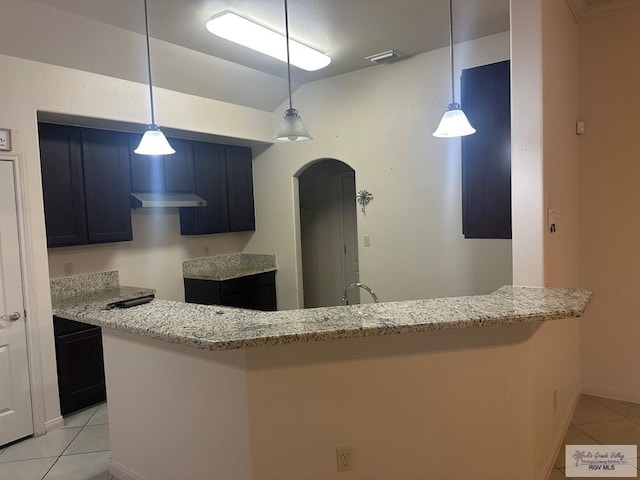 kitchen with visible vents, arched walkways, light stone counters, and light tile patterned flooring