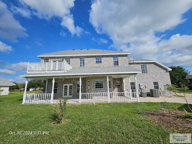 27406 Kelly Ct, La Feria, TX 78559 - rear view of property featuring a patio, central air condition unit, a yard, french doors, and brick siding