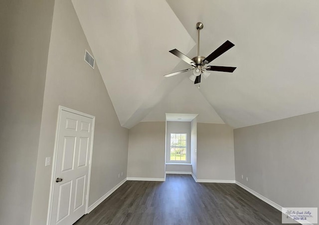 additional living space with dark wood finished floors, a ceiling fan, vaulted ceiling, and baseboards