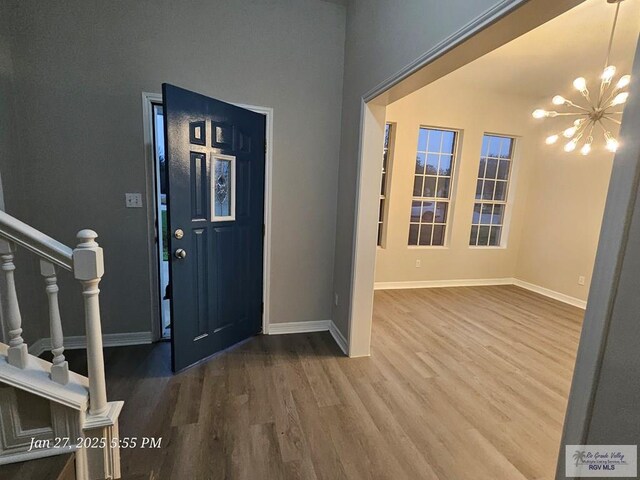 27406 Kelly Ct, La Feria, TX 78559 - foyer featuring wood finished floors, baseboards, a chandelier, and stairway