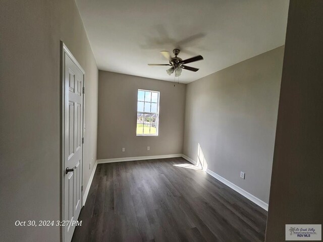 27406 Kelly Ct, La Feria, TX 78559 - spare room with ceiling fan, dark wood-style floors, and baseboards