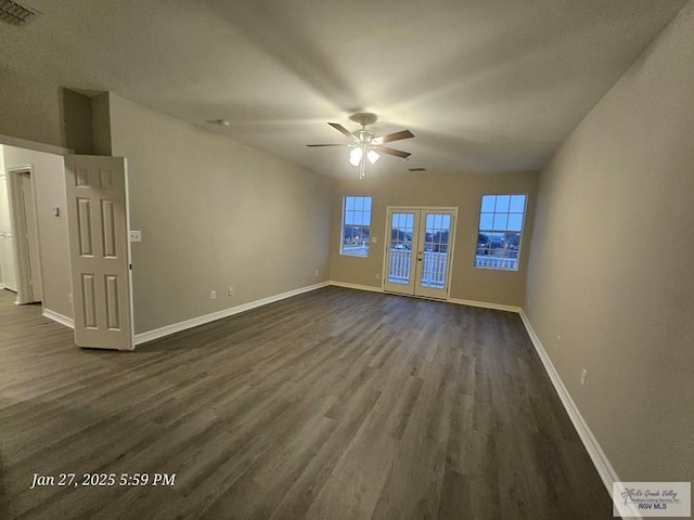 unfurnished living room with a ceiling fan, dark wood finished floors, baseboards, and french doors