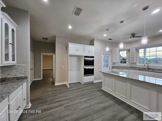 kitchen with a sink, white cabinets, ceiling fan, light stone countertops, and recessed lighting