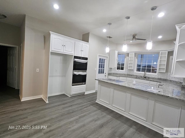 kitchen featuring open shelves, stainless steel double oven, white cabinets, dark wood-style floors, and recessed lighting