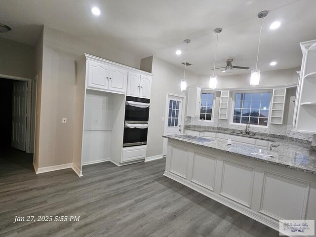 27406 Kelly Ct, La Feria, TX 78559 - kitchen featuring open shelves, stainless steel double oven, white cabinets, dark wood-style floors, and recessed lighting