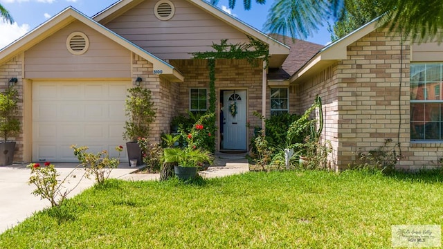 view of front of house with a shingled roof, concrete driveway, an attached garage, a front yard, and brick siding