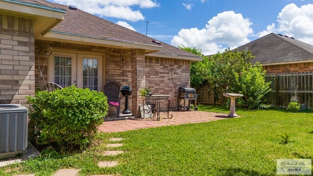 view of yard featuring fence, cooling unit, and a patio