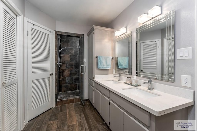 1916 Loquat Dr, Harlingen, TX 78552 - bathroom featuring a closet, double vanity, and a stall shower