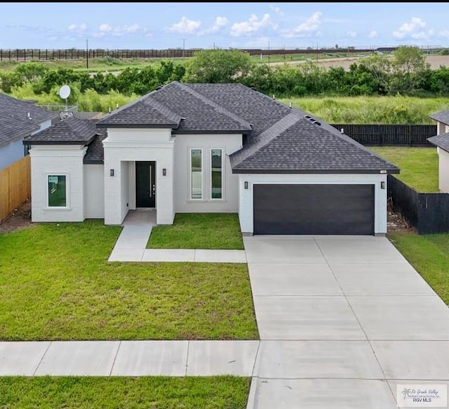 view of front of house featuring a garage and a front yard