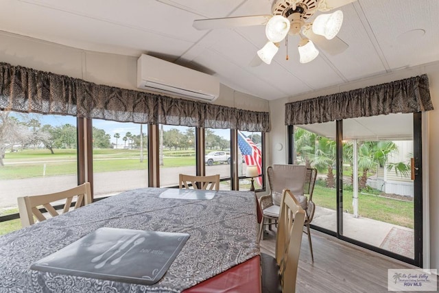 sunroom with a ceiling fan, lofted ceiling, and a wall mounted AC