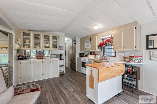 kitchen with dark wood-style floors, white appliances, light countertops, and a peninsula